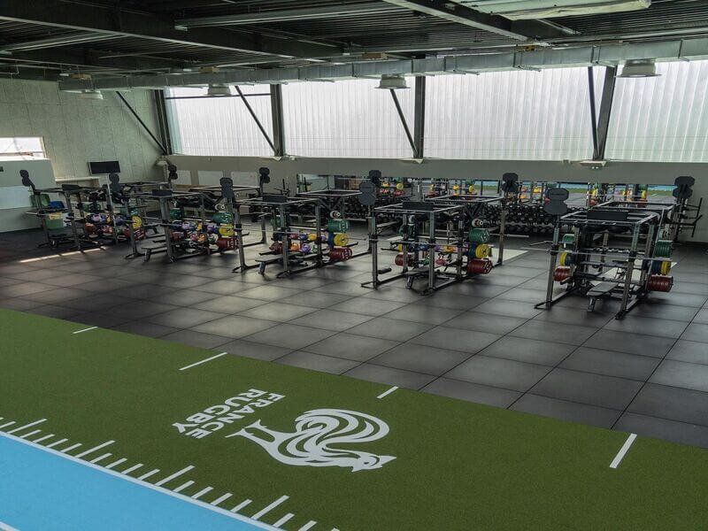 Close-up shot showing the green fibers and cushion backing of padded turf